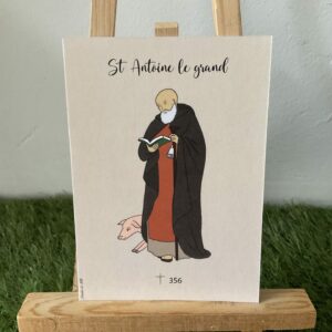 Carte de saint Antoine le grand, représente avec ses attributs: le cochon, le livre, la cloche et le tau. Imprimée au format A6 sur du papier. 300g. 